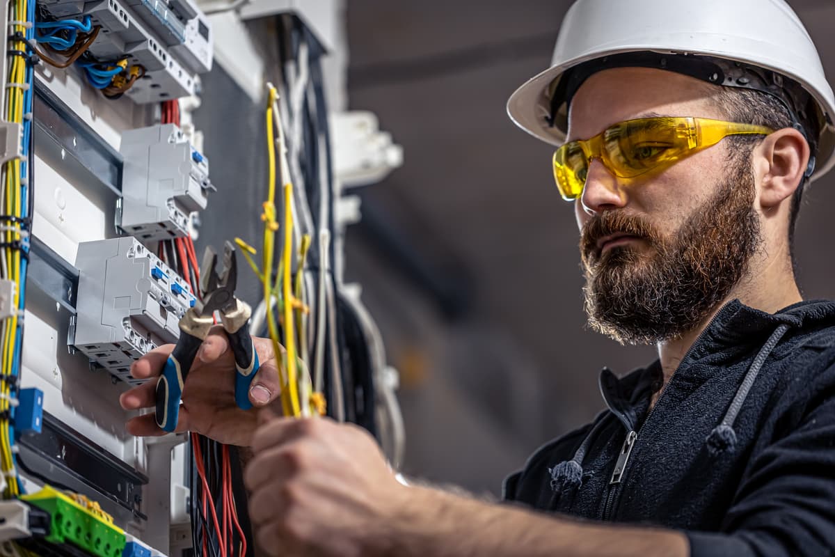 Electrician installing wiring for a new power socket